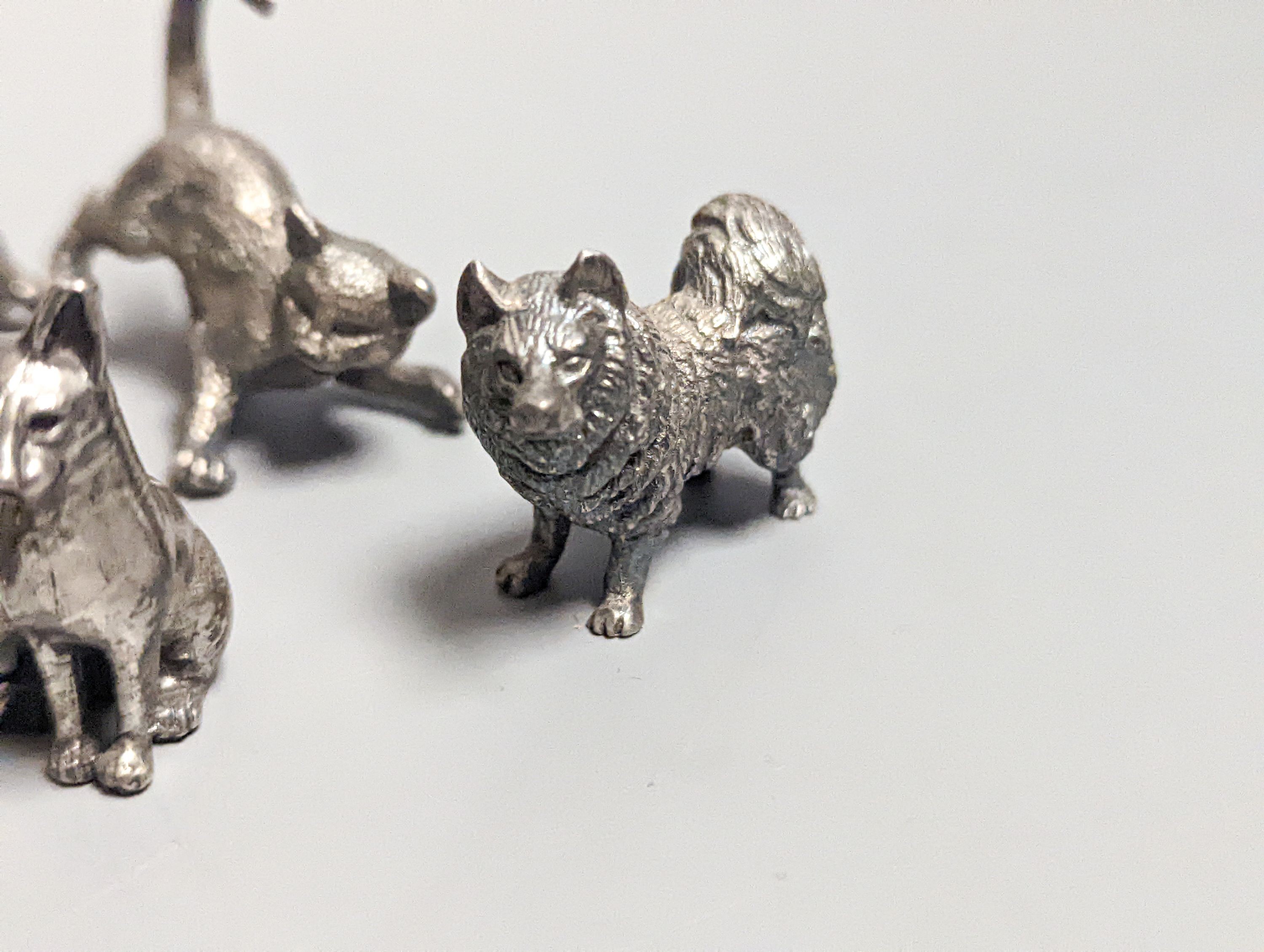 Four modern miniature freestanding model animals, including, badger, two dogs and a cat, JJSM, London, 1989 &1991, cat length 37mm, two Italian 925 models and two base metal models.
